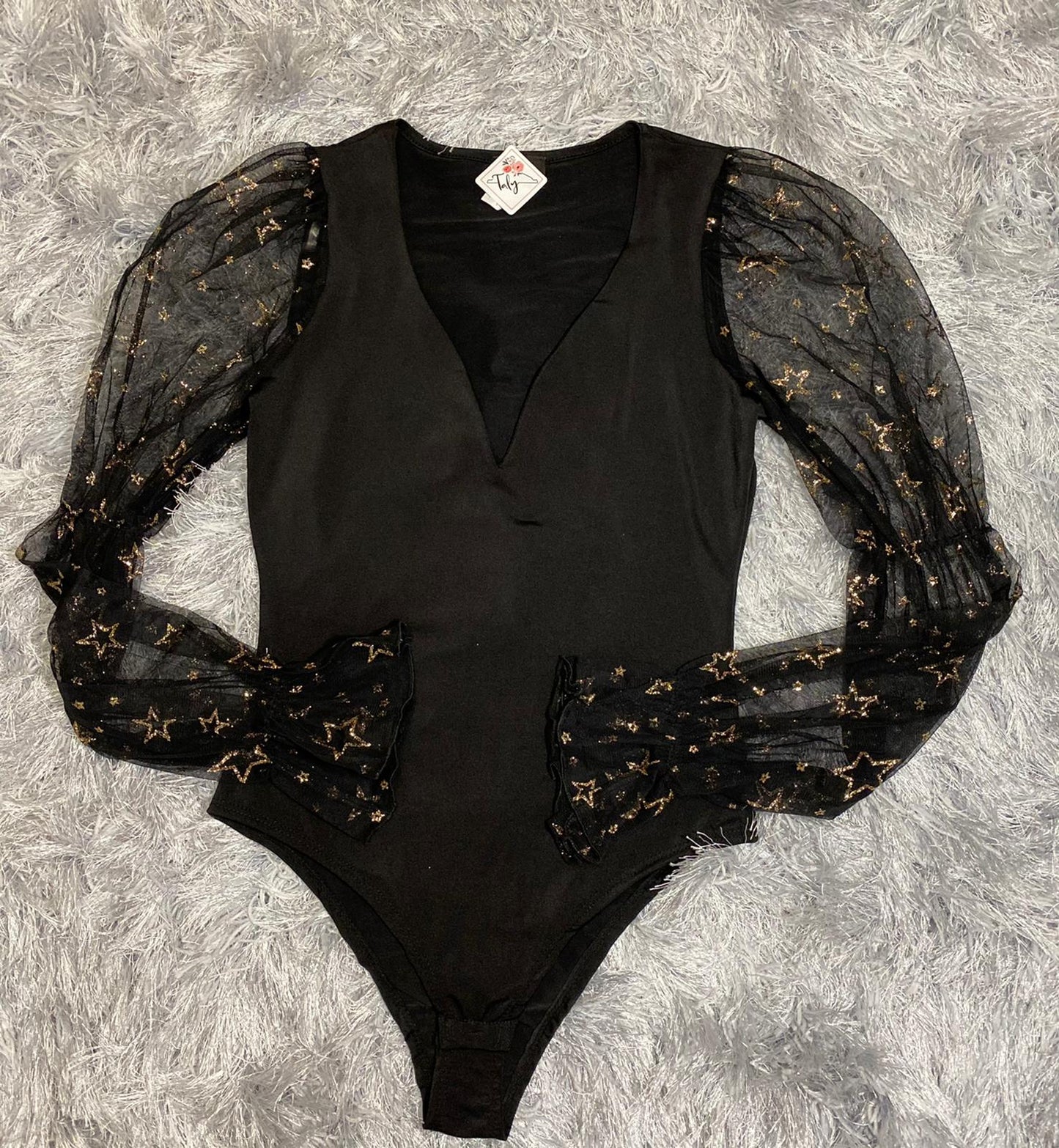 Bodysuit with transparency on sleeves and golden stars pattern.